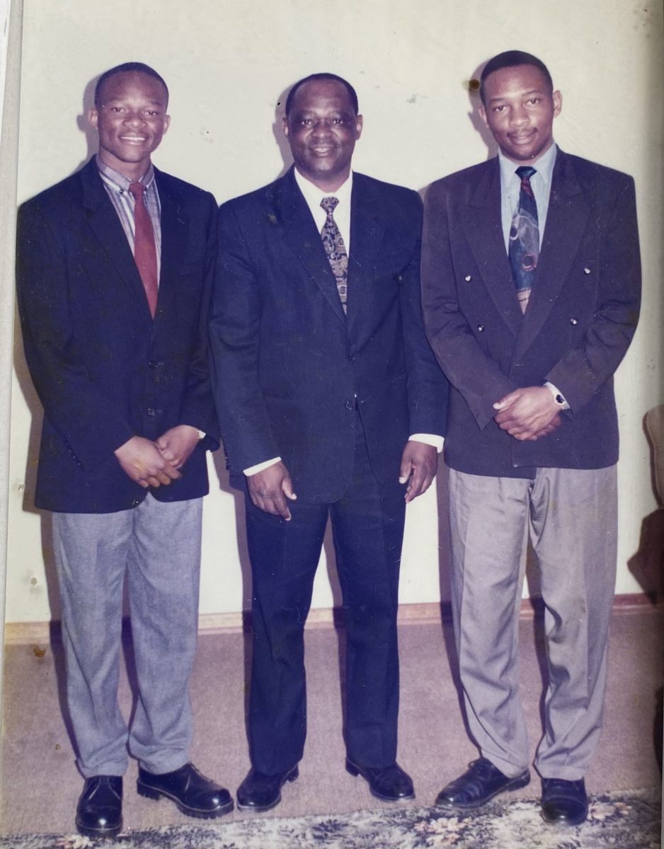 Three men in suits standing side by side